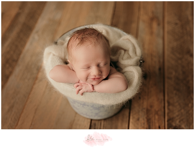 Baby smiling in a bucket